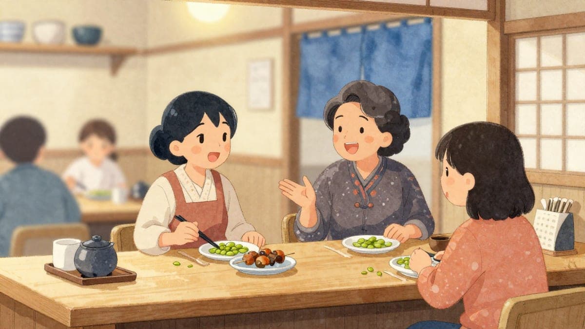 Seorang pelajar pertengahan umur dan seorang wanita muda Jepun ketawa bersama-sama di kaunter kayu kecil, berkongsi makanan ringan selepas kelas